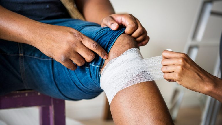 Person's leg being wrapped by another peson