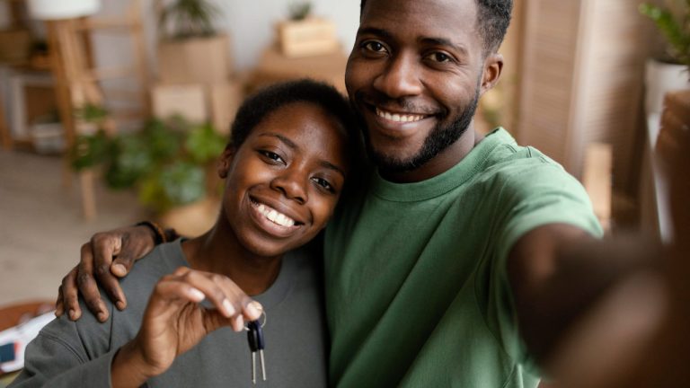 smiley-couple-taking-selfie-their-new-home